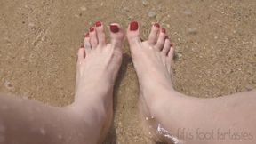 Fifi showing off her feet in the sand and waves at the beach