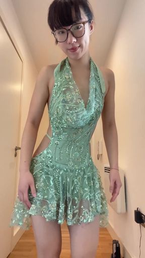 Slim solo babe poses in a new party dress. She stands tall, showing