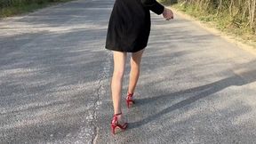 girl in high-heeled sandals got stuck in glue on the road and got stuck, while she tries to get out, a crazy fan crushes her toes