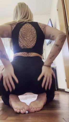 Woman in black tank top and shorts, bending over with hands on knees