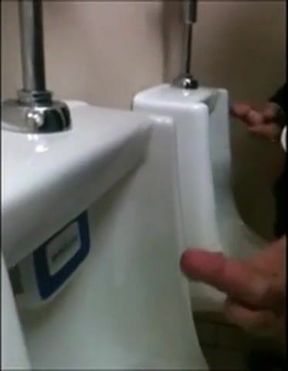 two slim dicks getting wanked at the urinals