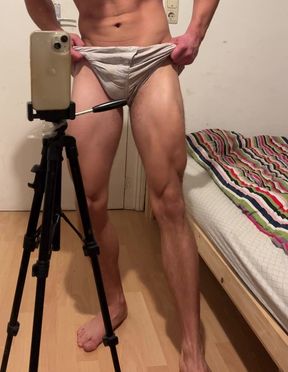 Young bodybuilder displaying off his muscles in boxer cut-offs