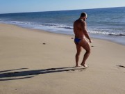 Beach walking in tiny bikini