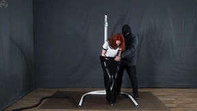 Sonya is in a black vacuum cocoon on a swing