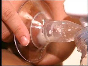 Lactating brunette massages her tits and squeezes milk from her nips