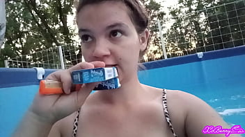 Hot brunette smoking in swimming pool