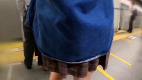 Shibuya Stroll: Young Woman's Chic Ponytail Style Meets Mini-Skirt Elegance - Glossy