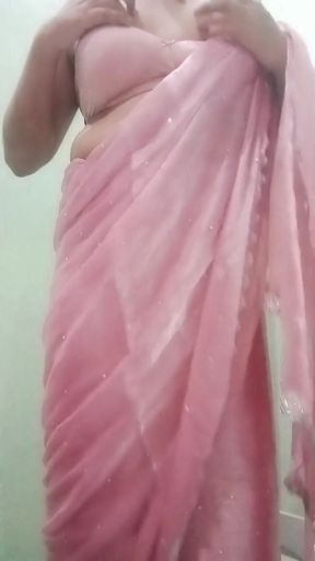 Indian Gay Crossdresser Gaurisissy Pressing and Playing with Her Big Boobs Looking in Pink Saree Looking Like a Housewife