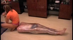 Nasty mistress tied up her slave with a plastic foil