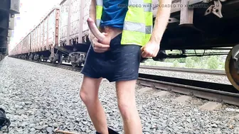 Hairy railway worker fills a used condom outdoors
