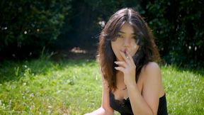Arina Is Smoking One Black Cigarette Outdoors