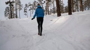 Long sexy legs in high heels walking in the snow and falling through it - Pretty girl storming up a snowy hill