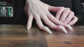 3 cm natural claws scratching wooden table