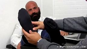 Bald bearded hunk foot worshipped and licked by young lad