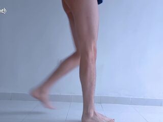 Lengthy legs and hot feet doing squats during the time that stripping