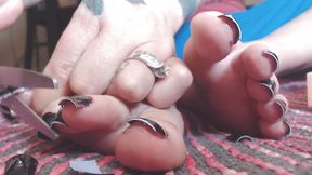 Cutting off long fake black toe nails