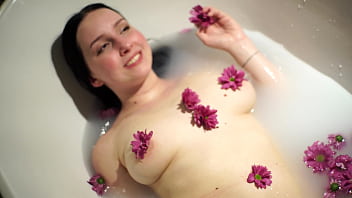 Beautiful Bella in bath of full of flowers