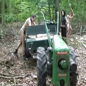 Dark haired German lady making her slaves chop wood