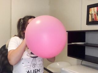 Cute pink balloon popped by blowing hard in it