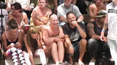 Naked girls are wrestling in front of a huge crowd