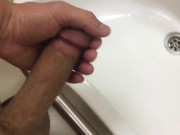 Cum flows down the wall of a public toilet