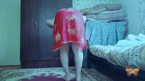 Playful femboy bending forward in short denim skirt