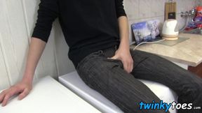 Young man on washing machine masturbates and plays with feet