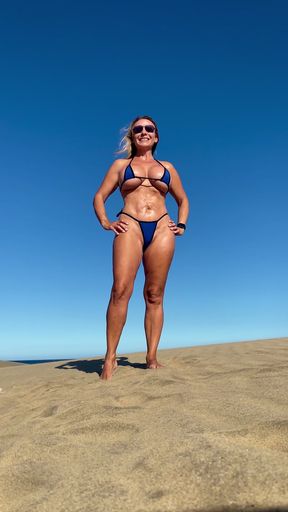 Beach babe in a bikini gets some sun