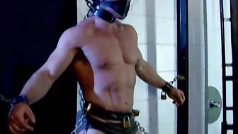 Derek Pain bound in chains and flogged by muscular dom