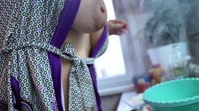A milf prepares a salad in an open robe without panties, flashing her tits and pussy.