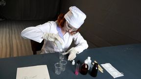 Laboratory technician in a vacuum bed with a pear gag and vibro