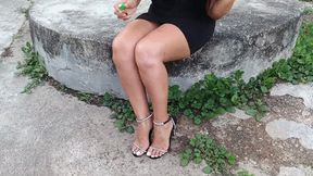 High heels dangling from the feet of a woman sitting cross-legged (3)