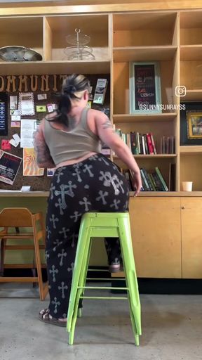 Woman sitting on stool in store