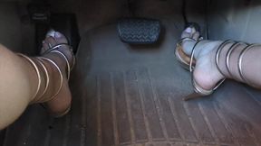 Fifi teasing and pumping the pedals before driving around in reveling gold heels that wrap up the leg