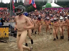 Wild folks wearing a helmet run naked on a cross track