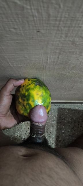 An Indian man enjoys the pleasure of inserting his penis into a papaya fruit