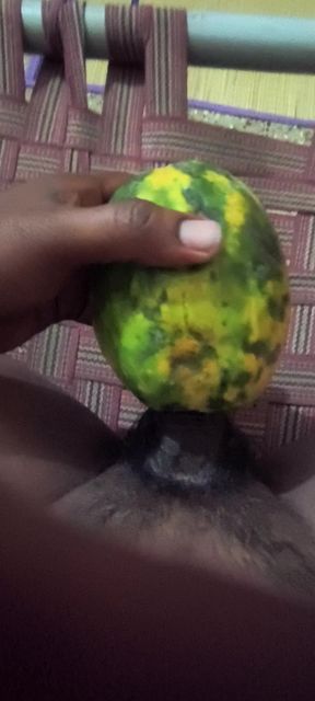An Indian man enjoys the pleasure of inserting his penis into a papaya fruit