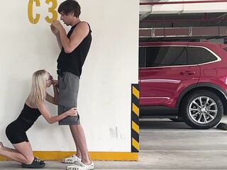 Unknown blond screws in a parking lot in plain sight