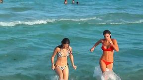 Two lesbians are looking to have a fun and swim in the ocean