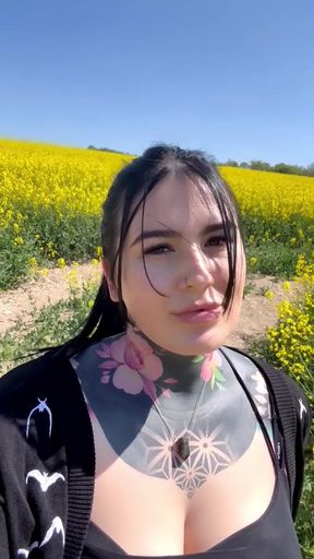 Tattooed woman in field