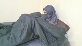 A woman in a hijab is masturbating on the sly.