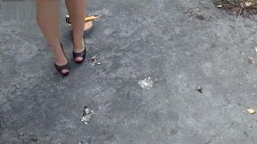 Irina outside crushing roaches in sharp sexy high heels.