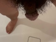 Chubby Japanese guy pees in the bathroom drain