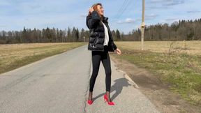 The girl in red shoes on high caboers goes on the road and comes on sticky dirt, heels stuck in this dirt, she loses her shoes on the go, pack her heels on her heels