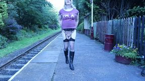 Crossdressed outdoors on a public railway platform