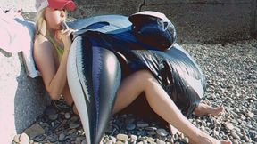 Alla inflates a big black inflatable whale on the beach with her mouth!!!