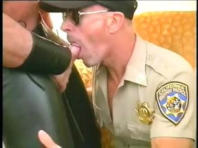 Muscular bear in leather chaps gets his cock slurped by police