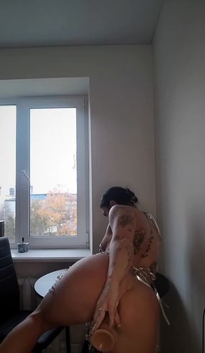 Nude woman sitting in front of window