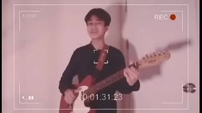 Sexy male singing song with guitar