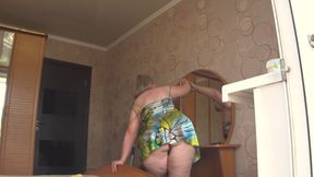 A neighbor watches a mature housewife through an open window.
